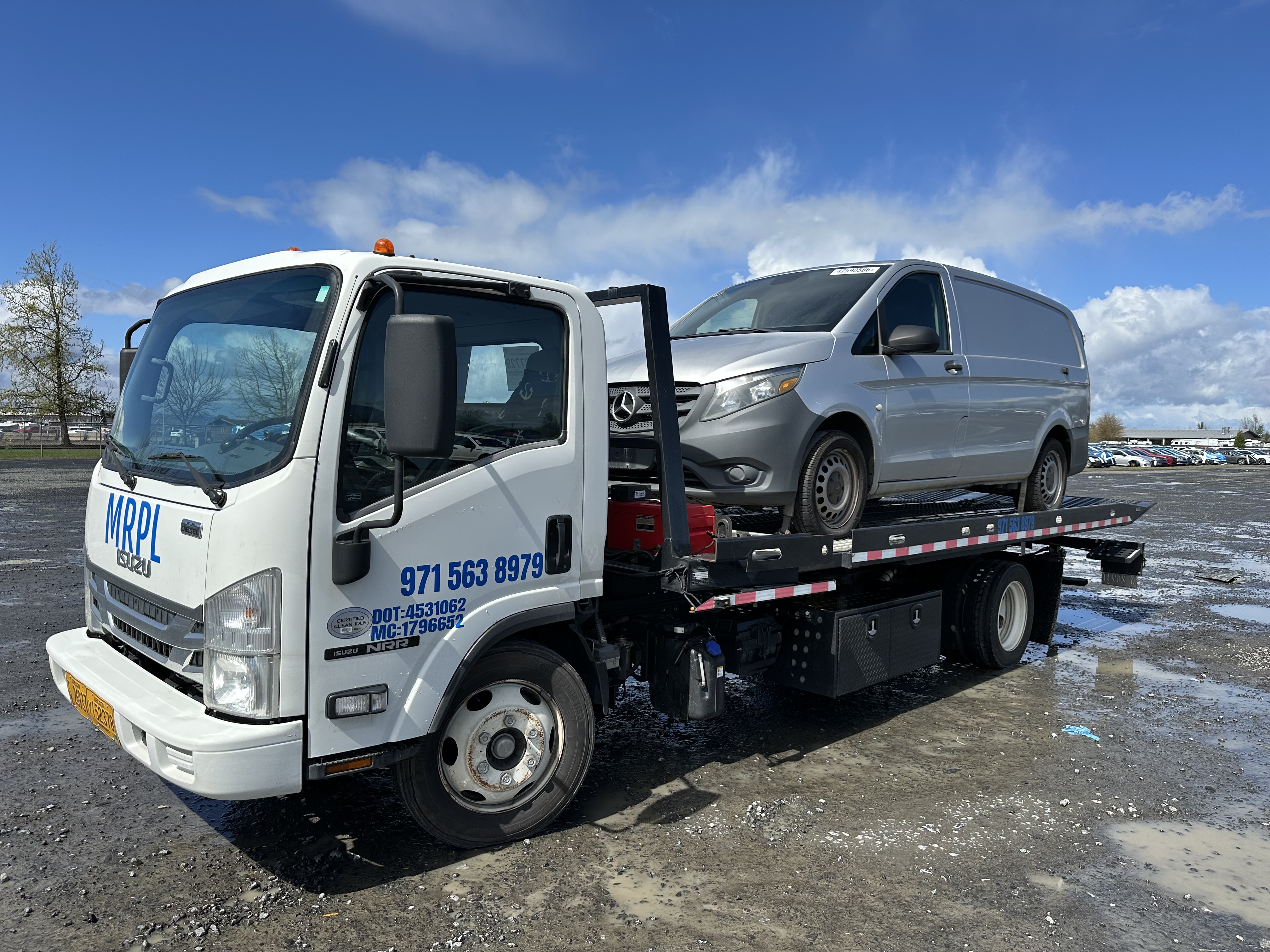 MRPL Towing flatbed tow truck carrying a gray Mercedes van in the Portland Metro area